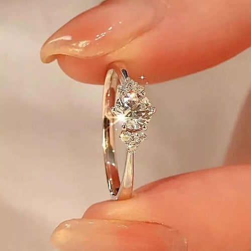 Sterling silver ring featuring a 1 carat moissanite gemstone, elegant jewelry piece with a sleek band design.