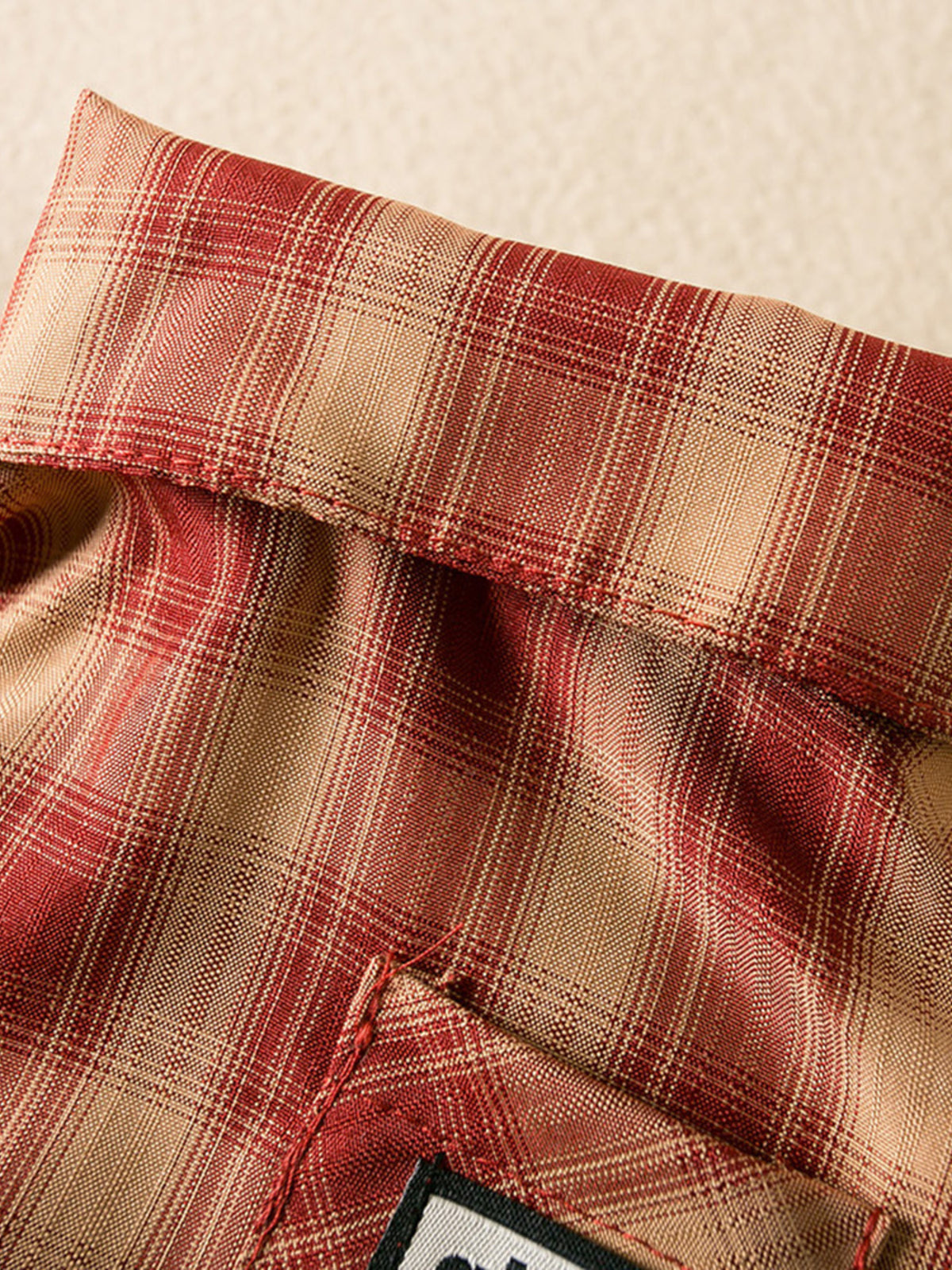 Plaid button-down pet shirt by Trendsi, featuring a stylish red and black checkered pattern for dogs or cats.
