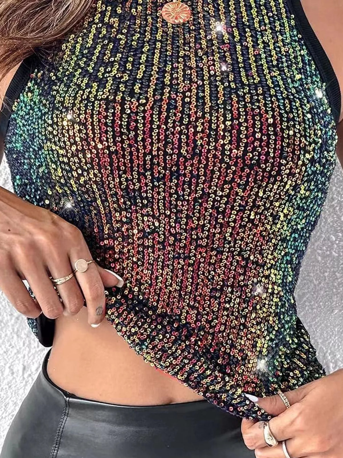 Sequin round neck tank top by Trendsi featuring shiny sequins and a sleeveless design on a mannequin.
